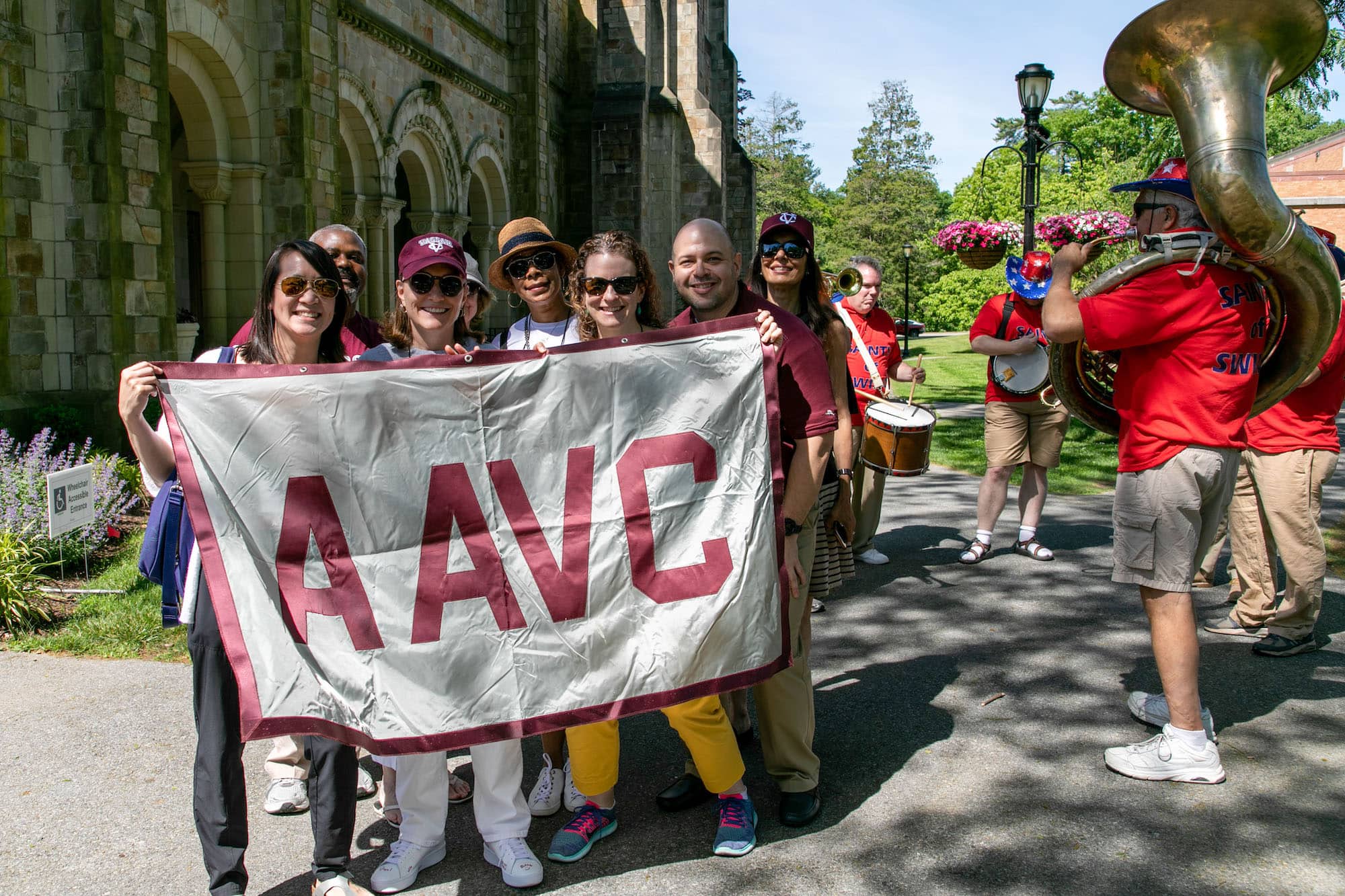 Group of people holding up an AAVC banner
